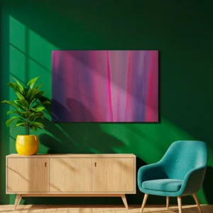 An unframed abstract canvas print mounted on a dark green wall. Sunlight casts a soft, diagonal shadow across the top left corner of the artwork and the wall