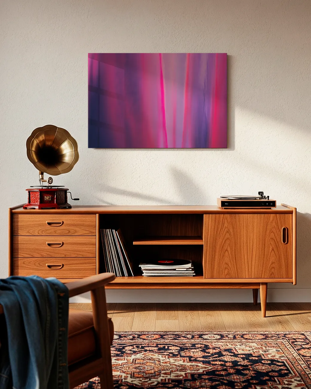 An unframed abstract metal print with a glossy finish hangs on a white wall above a mid-century modern wooden credenza. The credenza holds a vintage gramophone, vinyl records, and a turntable