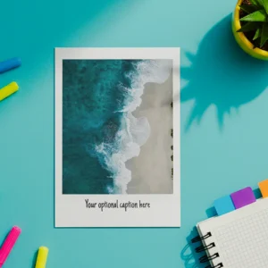A polaroid photo mockup lies centered on a teal background. Surrounding it are colorful markers, a small potted plant casting a shadow, and a spiral notebook with colorful tabs, creating a bright, creative atmosphere.